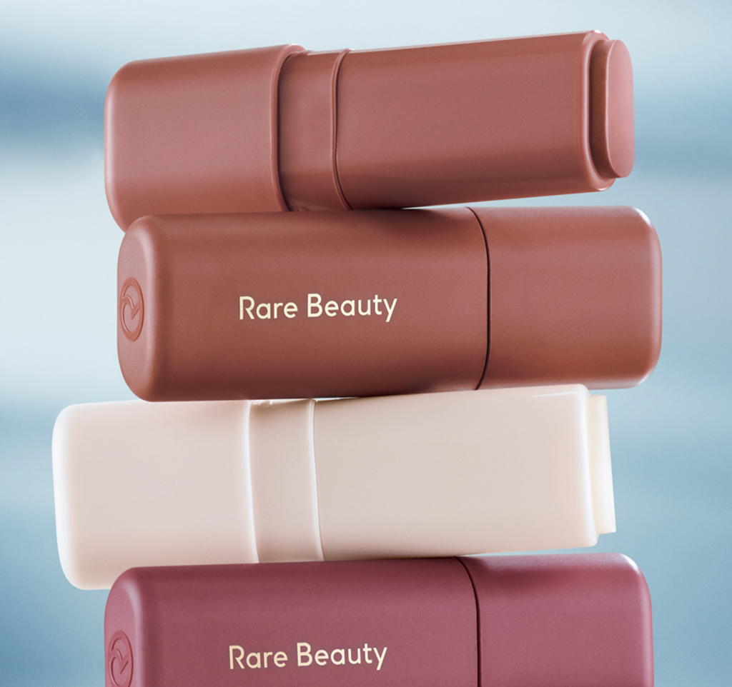 Stacked Rare Beauty Feel Seen sticks in soft tones that echo the line’s calm aesthetic and body-centered experience.