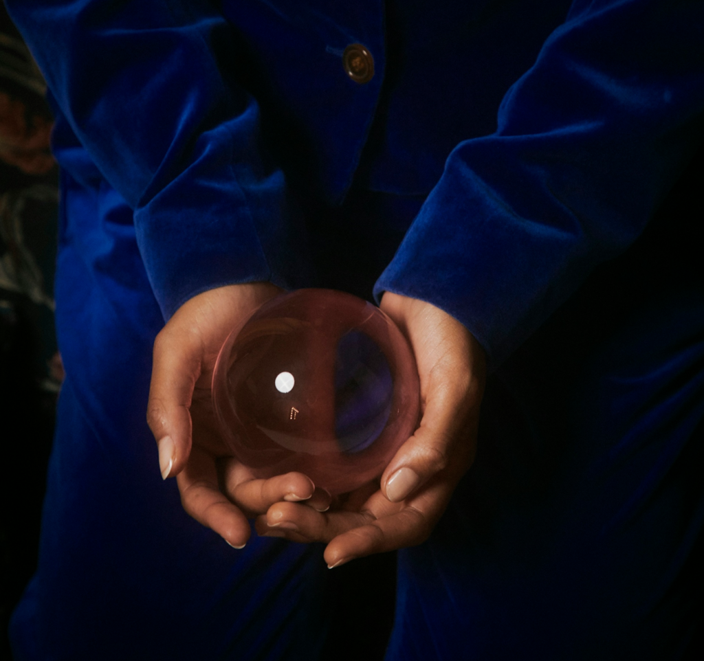 Hands holding a sphere as a symbol of numerology 2026, representing personal cycles and new beginnings.