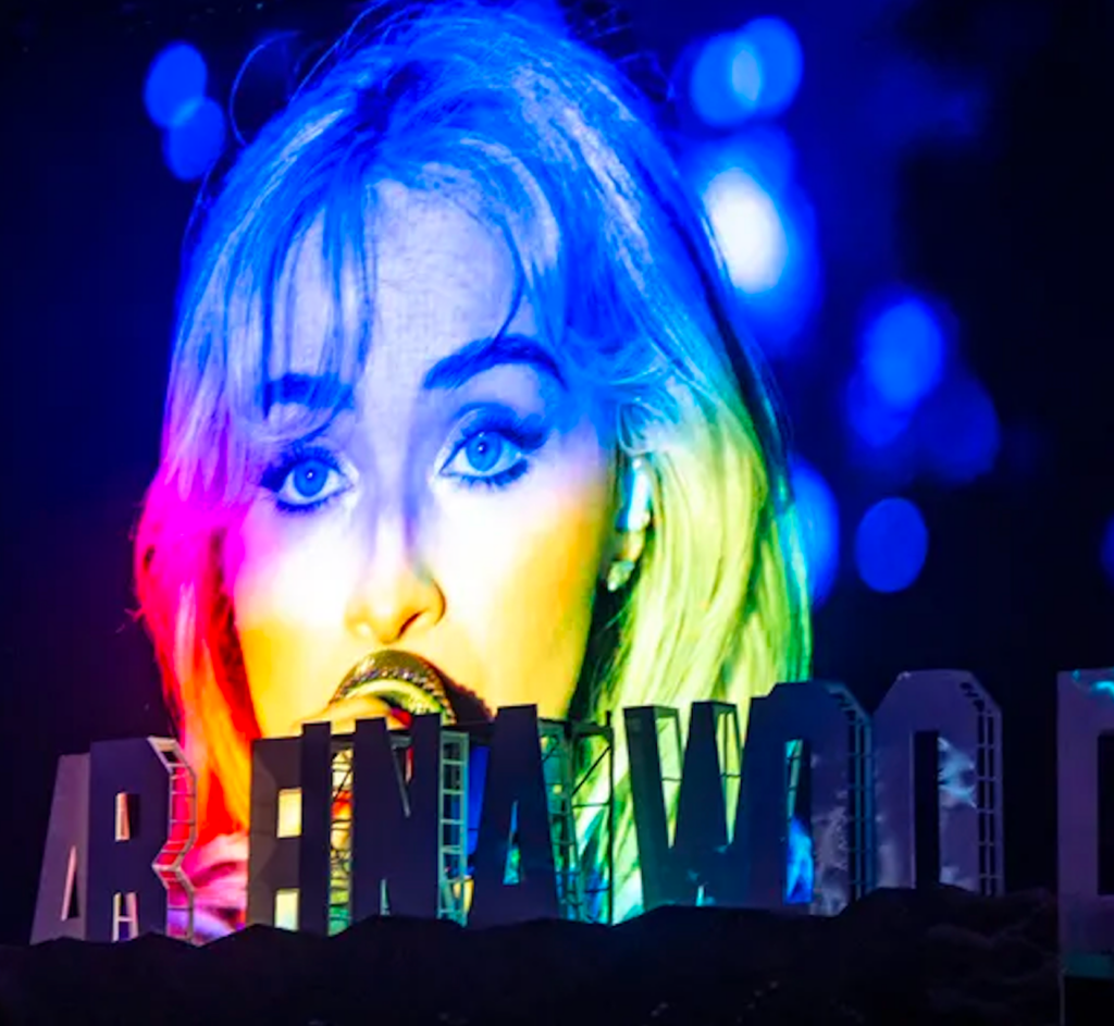 Sabrina Carpenter at Coachella 2026 with red lip and glam makeup
