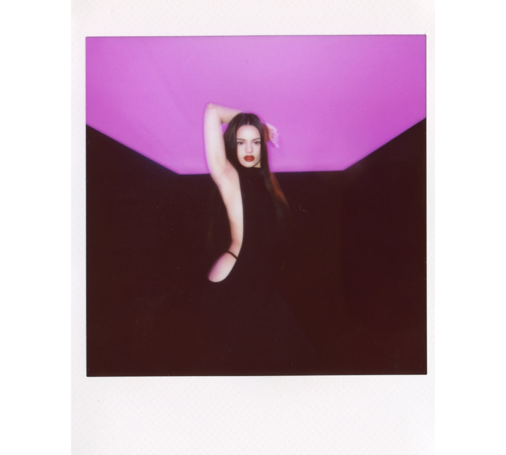 Backstage polaroid of Rosalía during the Calvin Klein euphoria elixirs campaign, capturing the intimate energy behind the intensity.