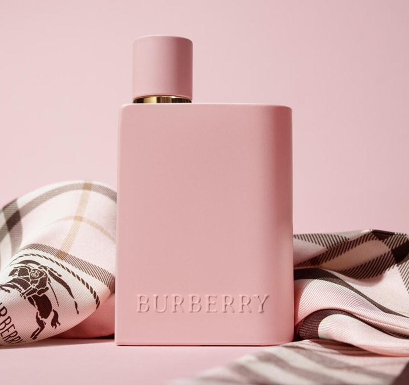 Matte pink Burberry Her Parfum bottle alongside Burberry's iconic check
