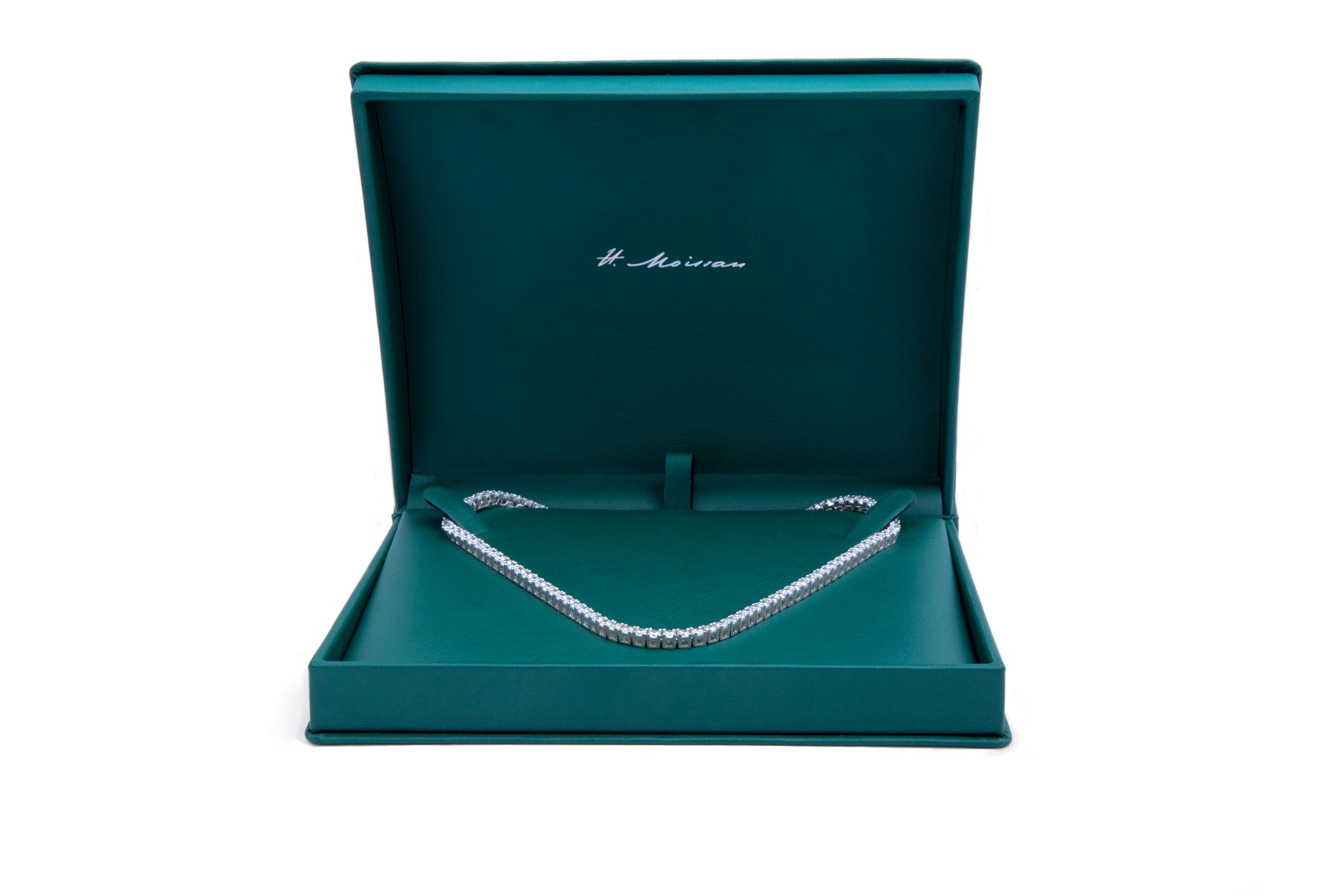 H. Moissan necklace presented in a green jewelry case