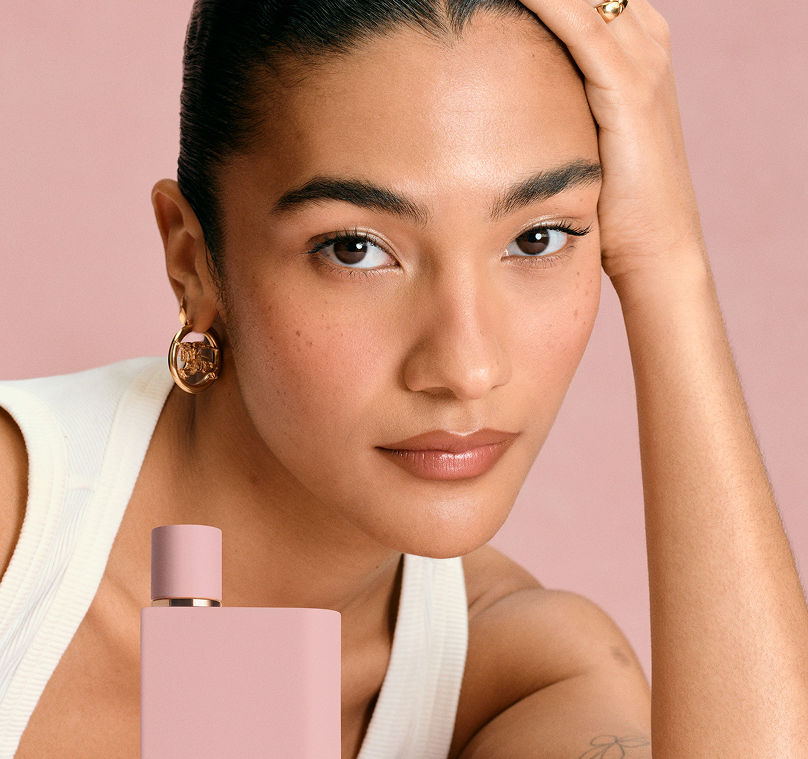 Olivia Dean with the pink Burberry Her Parfum bottle