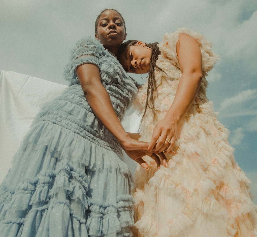 Sisters sharing a moment together, representing the bonds and roles we develop within a family